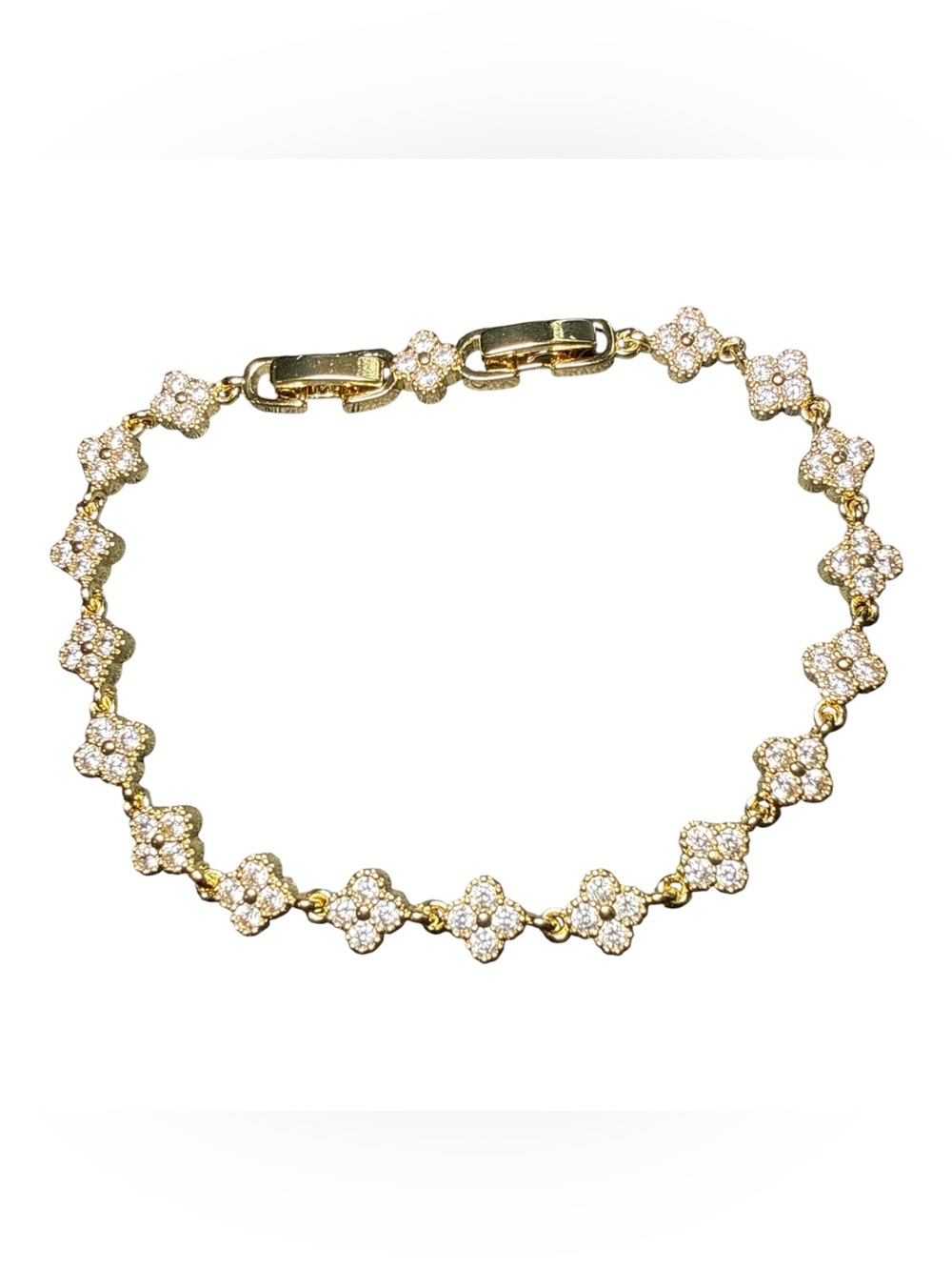 Gold-tone clover link bracelet featuring pavé-set cubic zirconia crystals